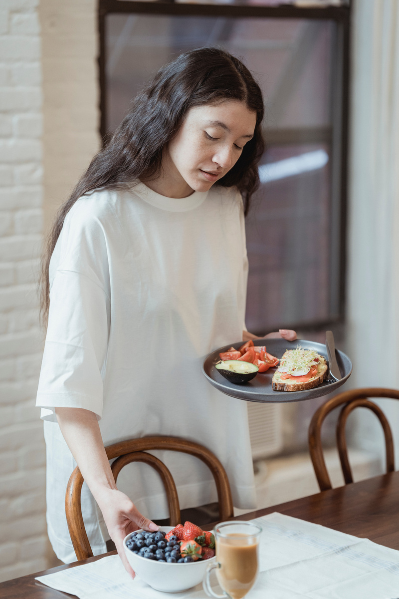 Woman with Food on Plate and in Bowl